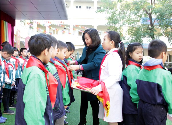 Hình ảnh cô giáo Phạm  Thị Mai Thanh - Phó Hiệu trưởng thắt khăn quàng cho các em đội viên 